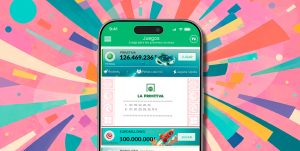 Móvil con la app de TuLotero y fondo de confeti, imagen ilustrativa sobre el mayor premio de La Primitiva