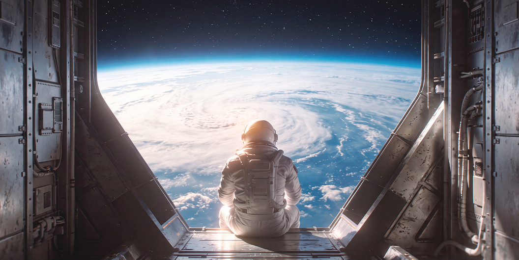 Astronauta contemplando la Tierra desde una nave, imagen ilustrativa del artículo sobre cuánto cuesta viajar al espacio.